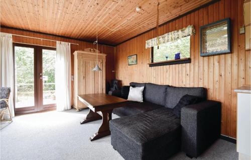 a living room with a couch and a table at Three-Bedroom Holiday Home In Ejstrupholm in Ejstrup
