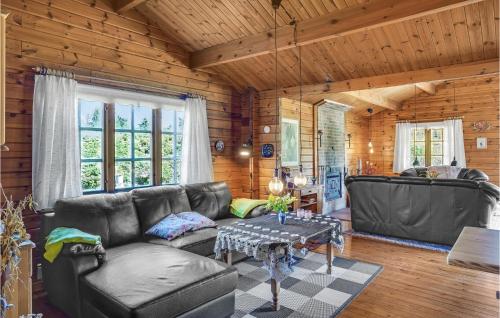a living room with a couch and a table at Three-Bedroom Holiday Home In Nykobing Sj in Klint