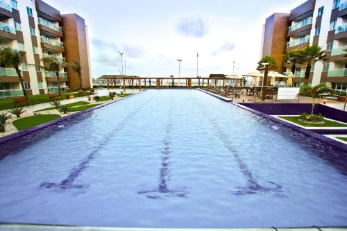 a swimming pool in the middle of a building at Sun Residence in Fortaleza