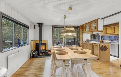 エーベルトフトにあるBeautiful Home In Ebeltoft With 3 Bedrooms And Wifiのキッチン(テーブル、椅子、暖炉付)