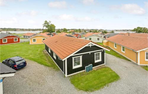 a black house with a car parked in a yard at Beautiful Home In Gråsten With Wifi in Gråsten