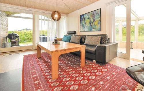 a living room with a couch and a table at Holiday Home Lundvej Sydals Denm in Vollerup
