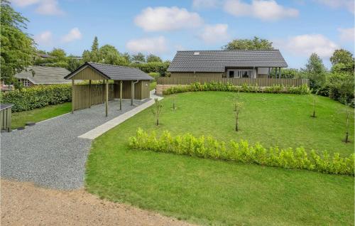 a garden with a house in the background at 3 Bedroom Beautiful Home In Hejls in Hejls