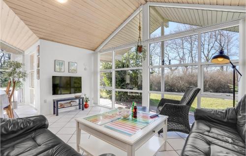 a living room with couches and a table at Beautiful Home In Storvorde With Sauna in Storvorde