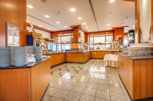 a restaurant kitchen with dishes on the counter at Congress Hotel Chemnitz in Chemnitz