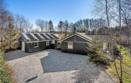 a house with solar panels on the side of it at Beautiful Home In Storvorde With Sauna in Storvorde
