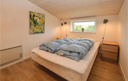 a large bed in a room with a window at Holiday Home Lundvej Sydals Denm in Vollerup