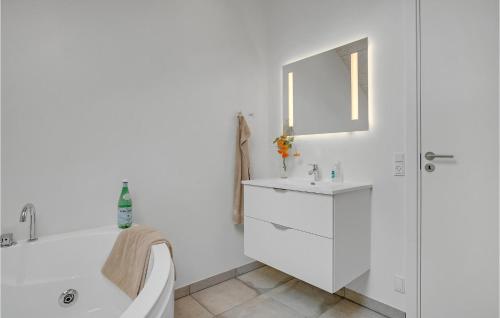a white bathroom with a tub and a sink at 3 Bedroom Beautiful Home In Hejls in Hejls