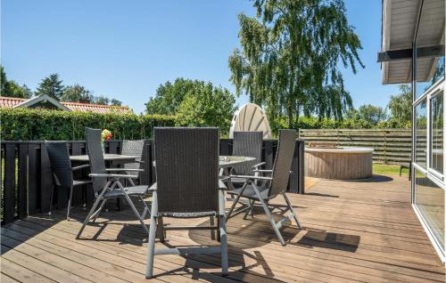 a patio with a table and chairs on a deck at Holiday Home Dannemare With Fireplace 11 in Dannemare