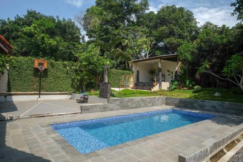 a swimming pool in the backyard of a house at SAREH VILLA by The Lavana in Semarang
