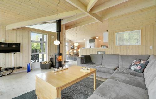 a living room with a couch and a table at Holiday Home Soløjevej in Marielyst