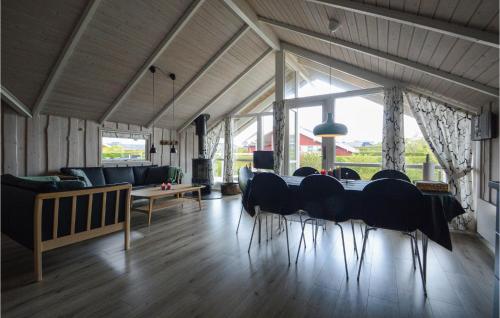 a dining room with a table and chairs and a couch at Four-Bedroom Holiday Home In Hejls in Hejls