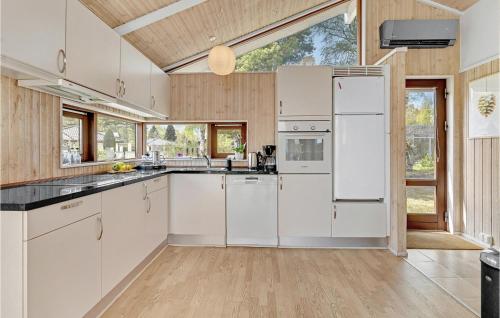 a kitchen with white appliances and a large window at Gorgeous Home In Egå With Wifi in Åstrup