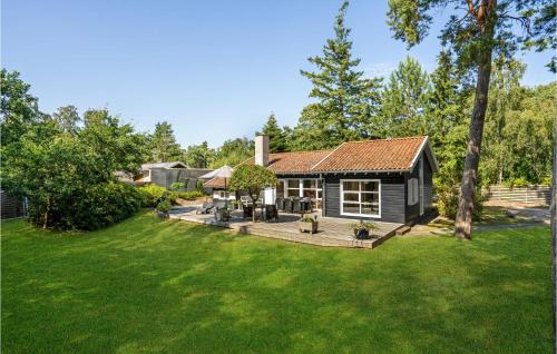 a house with a large yard with a deck at Holiday Home Hyldevej Væggerløse Ii in Marielyst