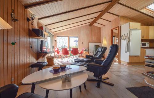 a living room with a table and chairs at Three-Bedroom Holiday Home In Hejls in Hejls