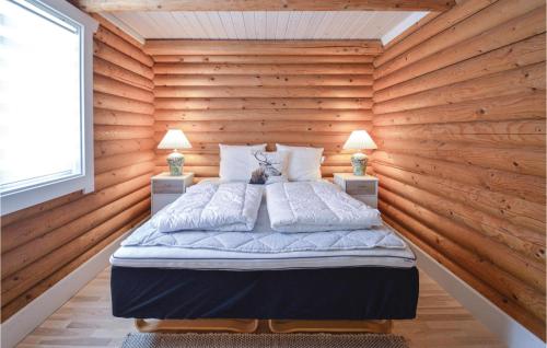 a bedroom with a bed in a wooden wall at Awesome Home In Lundby With Private Swimming Pool, Can Be Inside Or Outside in Lundby