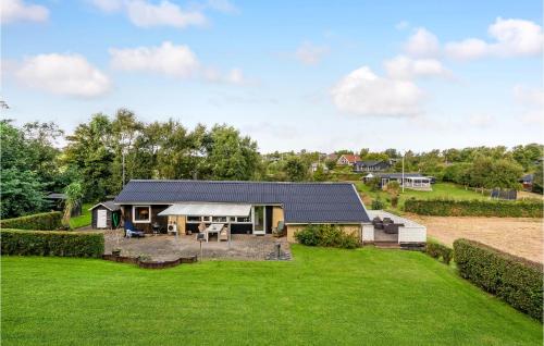 a home with a large yard with a house at Lovely Home In Roslev With Wifi in Roslev