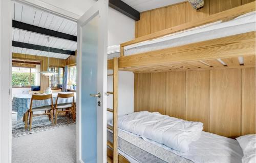 a bedroom with two bunk beds and a table at Gorgeous Home In Roskilde With Wifi in Roskilde