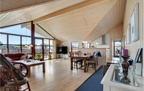 a living room with a wooden ceiling and a table at Awesome Home In Ansager With Wifi in Ansager