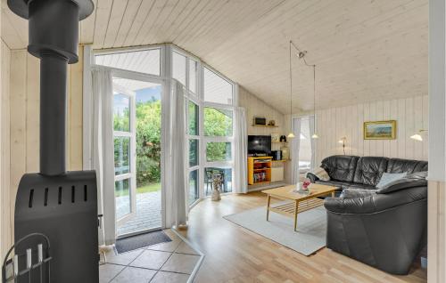 a living room with a wood stove at Holiday Home Flyndervej Tarm I in Hemmet