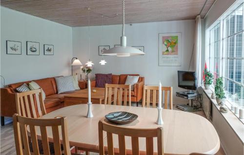 a dining room and living room with a table and chairs at 4 Bedroom Lovely Home In Nexø in Neksø
