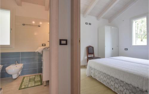 a bedroom with a bed and a bathroom with a sink at La Casa Gialla in Framura