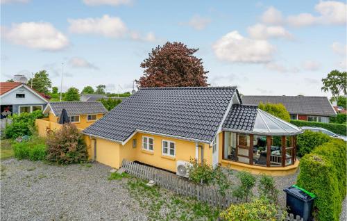 a yellow house with a gray roof at Stunning Home In Haderslev With Wifi in Haderslev