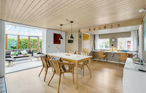 a kitchen and living room with a table and chairs at Stunning Home In Haderslev With Wifi in Haderslev