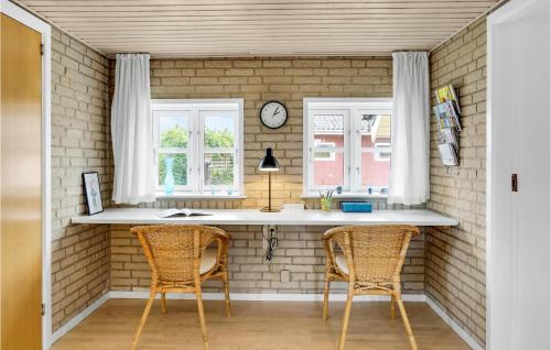a kitchen with two chairs and a counter and two windows at Stunning Home In Haderslev With Wifi in Haderslev