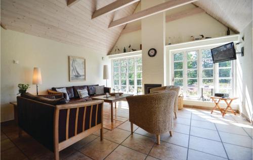 a living room with a couch and a table at Holiday Home Præstekraven Rømø in Rømø Kirkeby