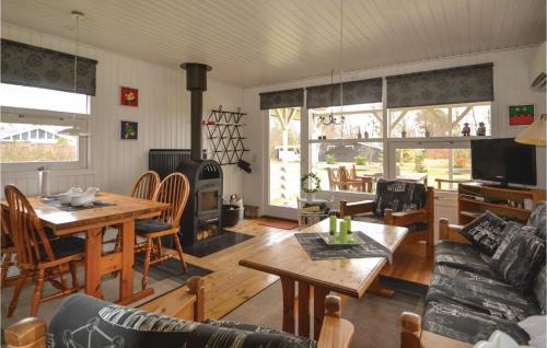 a living room with a couch and a table at Holiday Home Rylevej Ørsted Denm in Kare