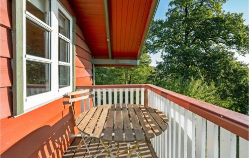 a wooden bench on the porch of a house at Strandly in Kelstrup Strand