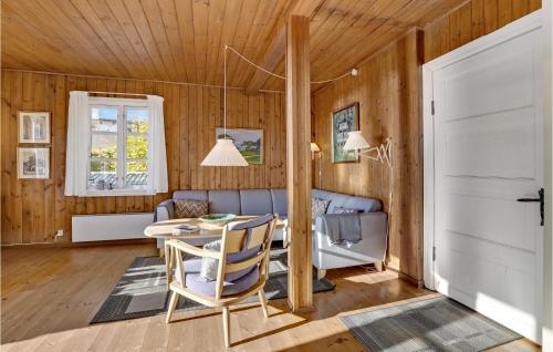 a living room with a table and a couch at Strandly in Kelstrup Strand
