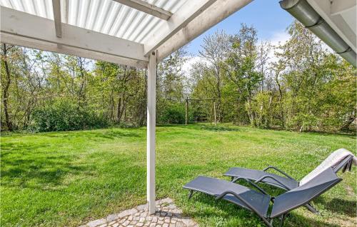 a couple of chairs sitting under a pergola at Joe in Rønne