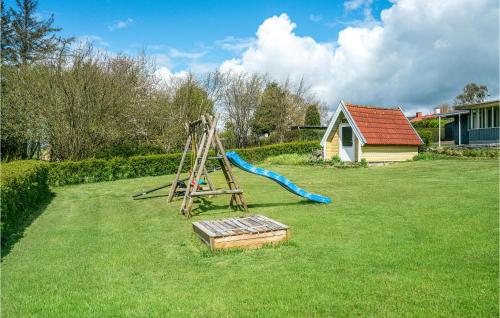 a playground with a slide in a yard at Holiday Home Brunshusevej in Brydegård