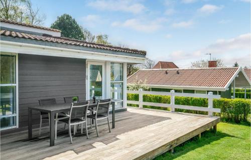 a wooden deck with a table and chairs on a house at Holiday Home Brunshusevej in Brydegård