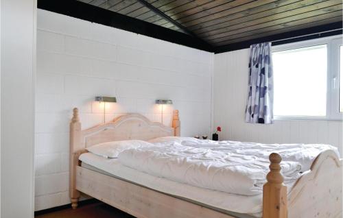 a white bedroom with a large bed with white sheets at 3 Bedroom Beautiful Home In Hvide Sande in Havrvig