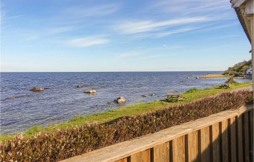 a view of the ocean from a wooden fence at 3 Bedroom Gorgeous Home In Hasle in Hasle