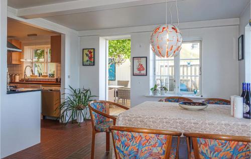 a kitchen and dining room with a table and chairs at 3 Bedroom Gorgeous Home In Hasle in Hasle