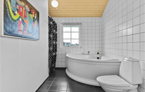 a white bathroom with a tub and a toilet at Nice Home In Nrre Nebel With Kitchen in Nørre Nebel