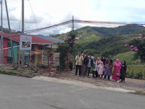 a group of people standing on the side of a road at MAK Homstay upstairs in Kundasang