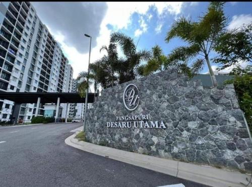 a sign for a resort in front of a building at Ai Qaseh Desaru Penawar Pool Apartment Homestay in Bandar Penawar