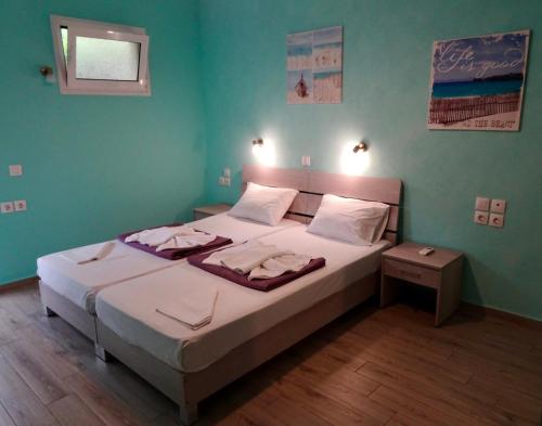 a bedroom with a large bed with white sheets at Faros apartment in Sfakiá