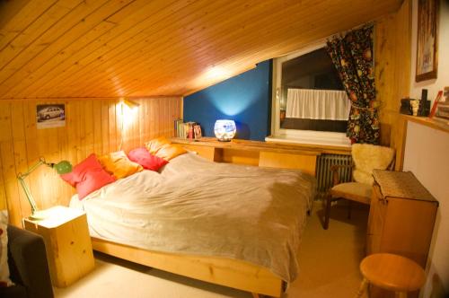 a bedroom with a bed and a desk and a chair at Haus Sonnenalm in Bad Mitterndorf