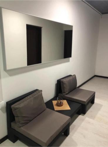 a living room with two couches and a mirror at Kapija Svrljiga in Svrljig