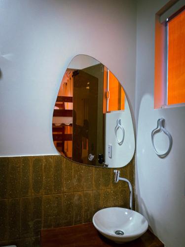 a bathroom with a sink and a mirror at Oka Pousada Atins in Atins