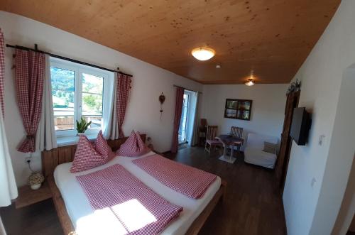 a bedroom with a bed with red and white pillows at Kornihof in Waidhofen an der Ybbs