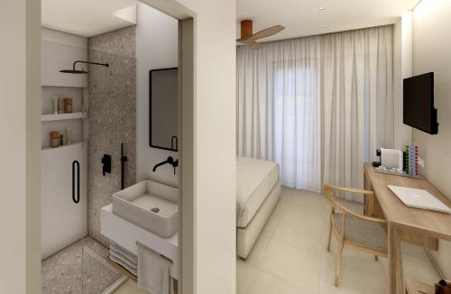 a bathroom with a sink and a desk at Agrelli Hotel & Suites in Kardamaina