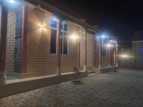 a brick building at night with lights on it at RS #10selous in Ukaranga