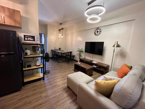 a living room with a couch and a tv and a table at 2 bedroom at Bristle Ridge in Baguio
